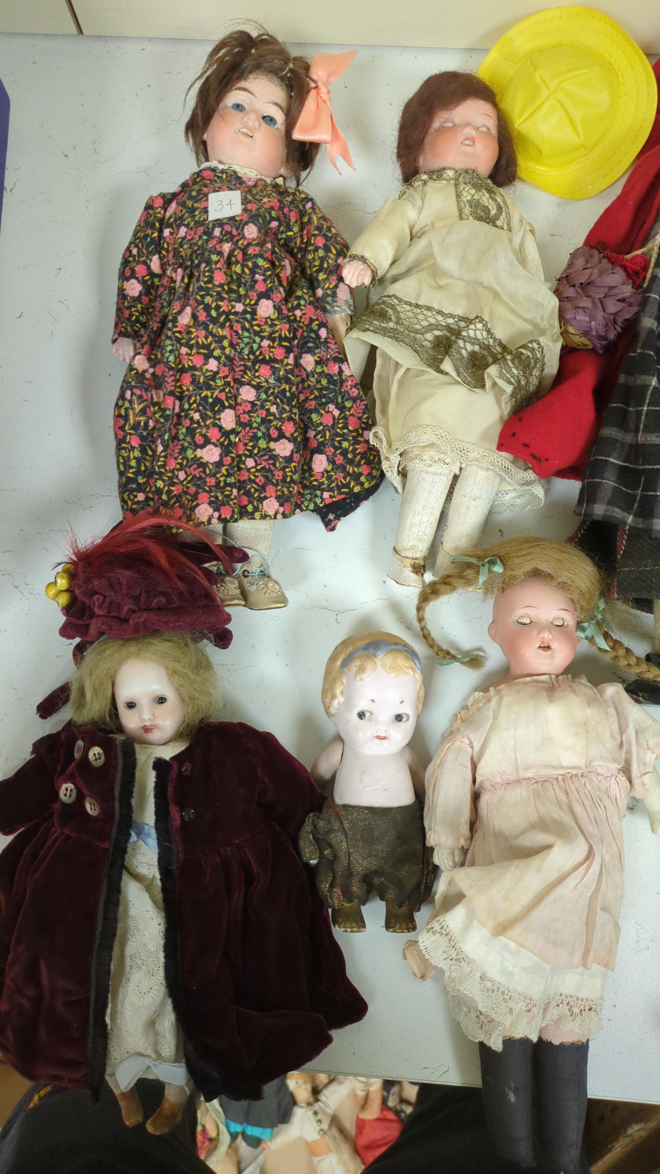 Nine assorted dolls including AMS and Kewpie small doll baby in cradle